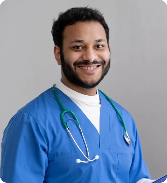Smiling male doctor in blue scrubs with a stethoscope, symbolizing healthcare professionalism and care.
